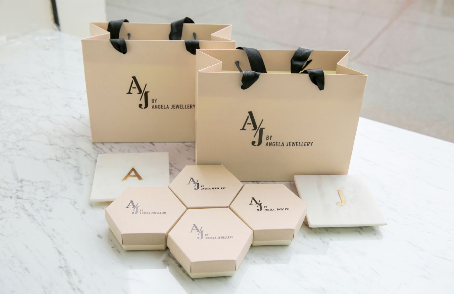 AJ by Angela Jewellery packaging — kraft shopping bags and hexagonal jewellery boxes